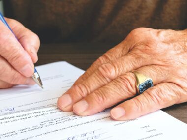 person signing document paper